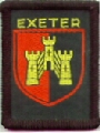 Centre of the arms of the City of Exeter. It is a very old set of arms, which can be seen from the badges simplicity. The Castle is a representation of Rougemont Castle set it the North East Corner of the Roman City Walls. Up to the mid-sixties the same Badge was used as the Devon County but with Devon instead of Exeter 